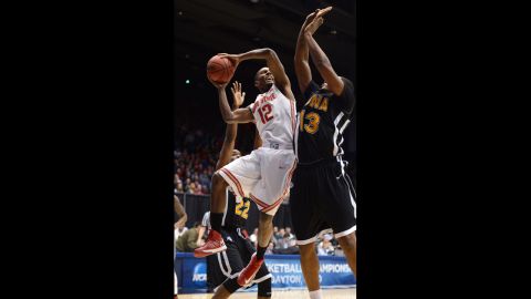Sam Thompson of the Ohio State Buckeyes, left, drives to the basket against David Laury of the Iona Gaels on March 22.