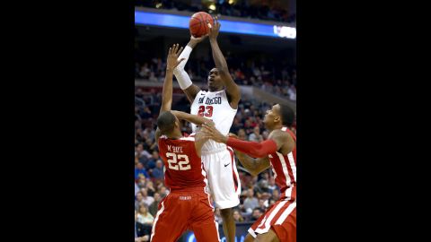 DeShawn Stephens of the San Diego State Aztecs, center, attempts a shot against Amath M'Baye of the Oklahoma Sooners on March 22.