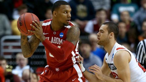 Cameron Clark of the Oklahoma Sooners, left, looks to pass against JJ O'Brien of the San Diego State Aztecs on March 22.