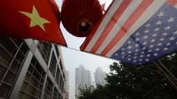 This photo taken on February 3, 2013 shows the US and Chinese flags flying outside an office building in the downtown area of Chongqing, China.