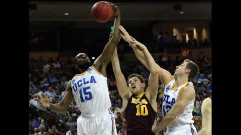 Oto Osenieks of the Minnesota Golden Gophers, center, goes between Shabazz Muhammad, left, and David Brown of the UCLA Bruins on March 22.