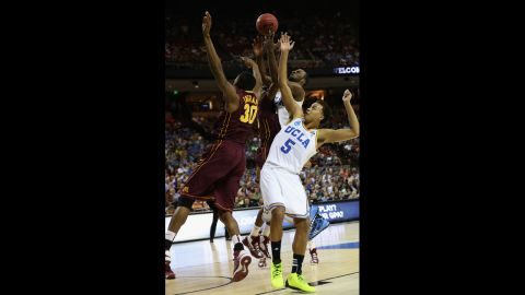 Kyle Anderson, right, and Shabazz Muhammad of the UCLA Bruins battle for the ball against Andre Ingram of the Minnesota Golden Gophers on March 22.