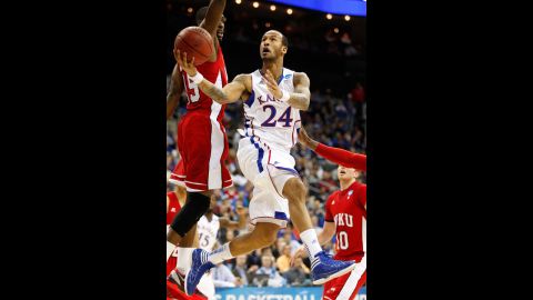 Travis Releford of the Kansas Jayhawks, center, shoots against O'Karo Akamune, left, and Caden Dickerson of the Western Kentucky Hilltoppers on March 22.