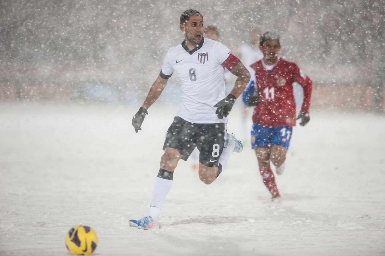 U.S. soccer player Clint Dempsey, No. 8, is surrounded by snow during a FIFA 2014 World Cup Qualifier match between Costa Rica and the United States in Commerce City, Colorado, on Friday, March 22. 