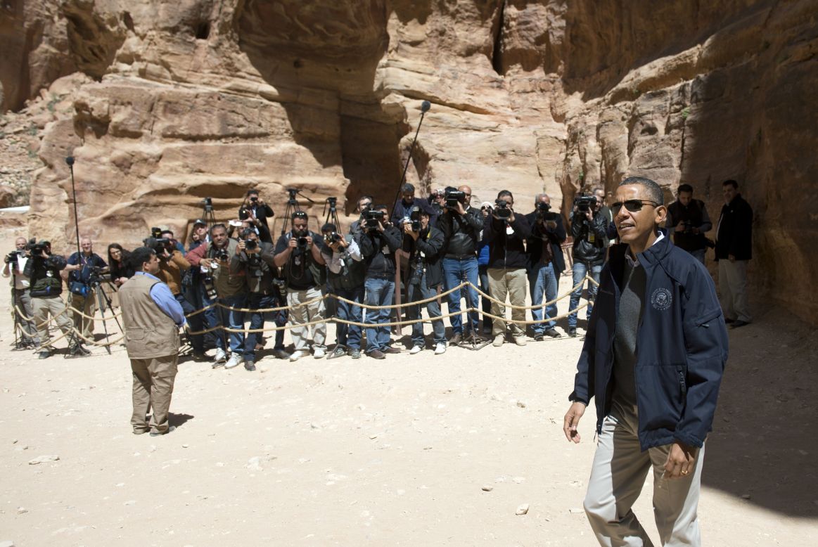 Obama walks past media during his tour of Petra on Saturday.