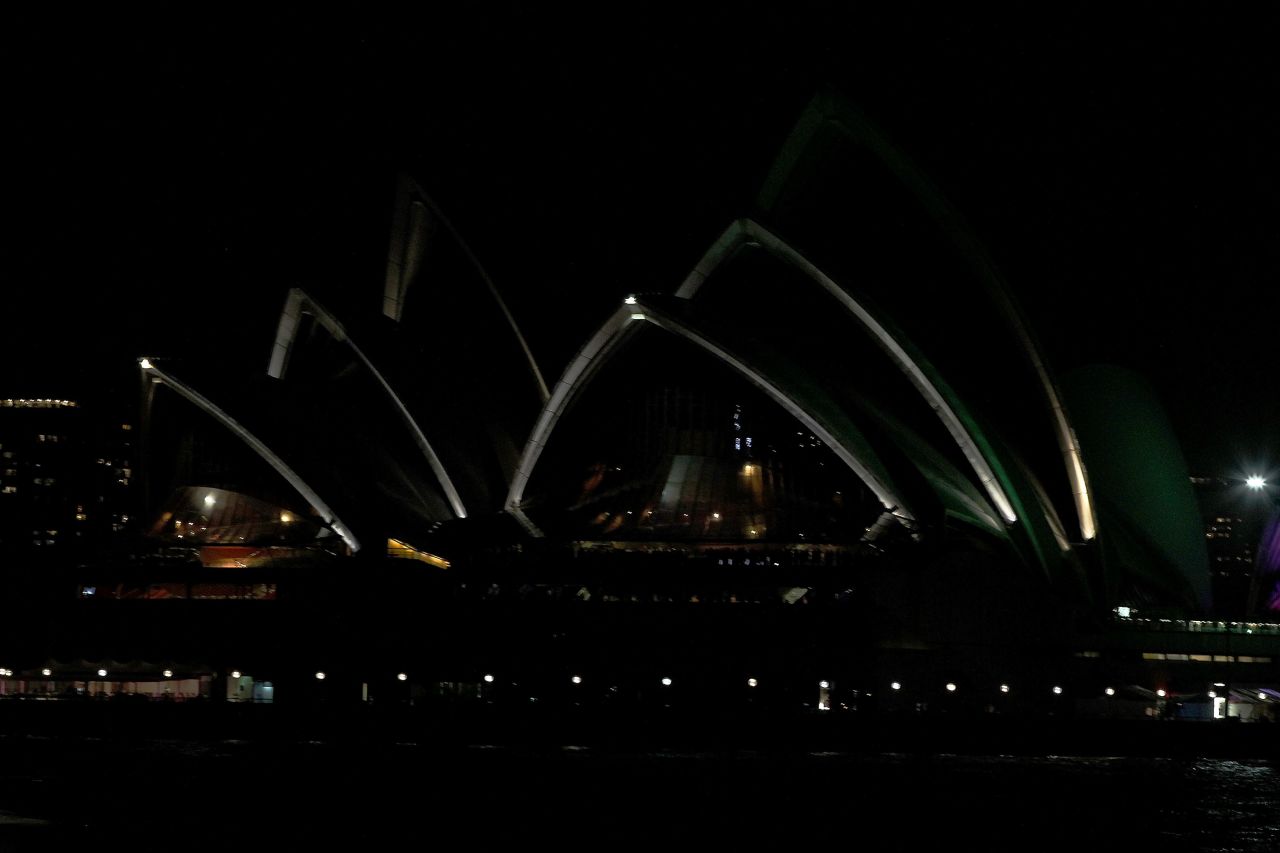 The Opera House is seen after the lights were switched to 'GreenPower' and glowed dark green to recognize Earth Hour.