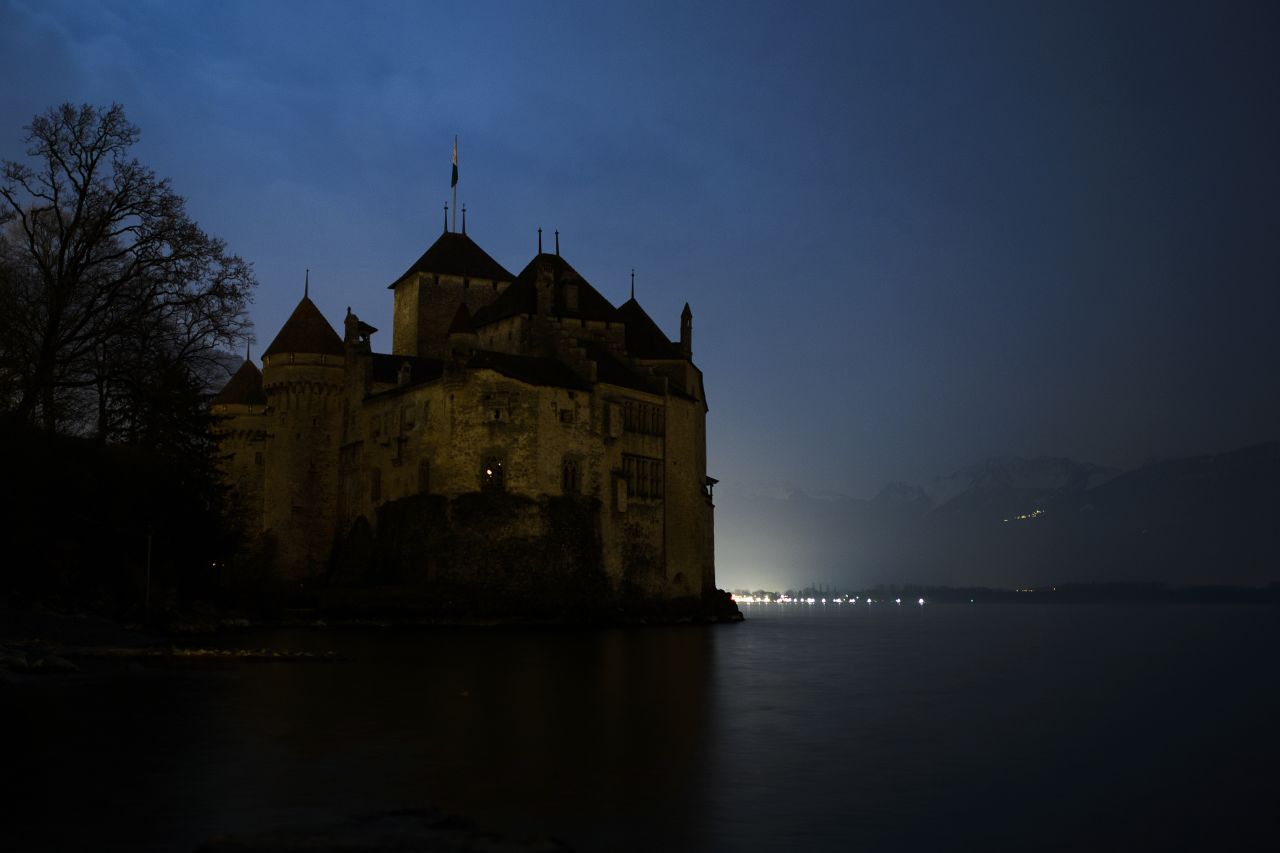The silhouette of the Chillon Castle is seen with lights off on the edge of Lake Geneva near Montreux during Earth Hour.