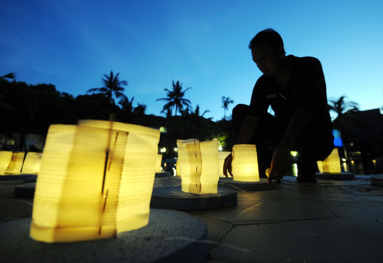 Balinese men burn lanterns during Earth Hour at a hotel in Nusa Dua on the resort island of Bali.