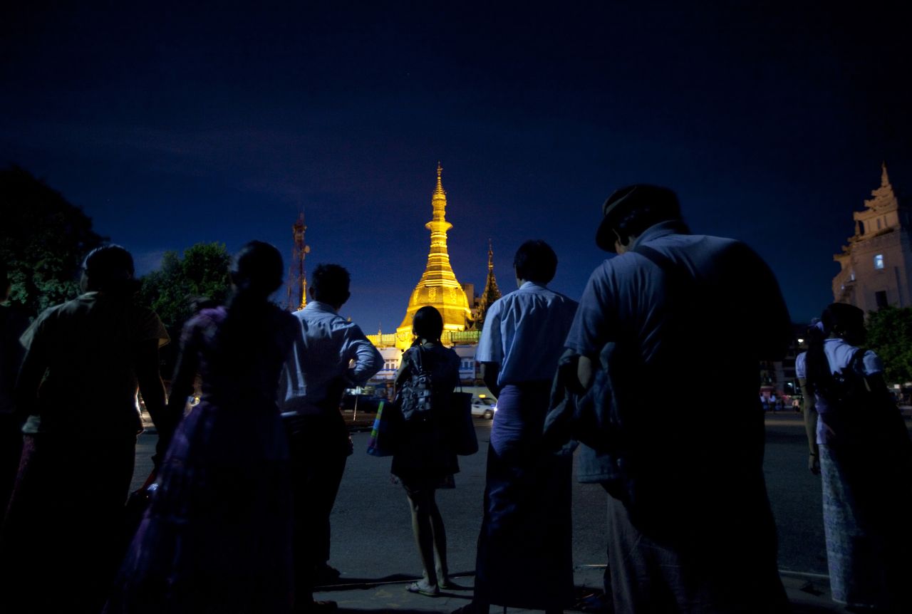 The Sule Pagoda lights up the night sky as people wait for the bus in Yangon. Pagodas serve as shrines for Theravada Buddhists, the majority religion in the country.