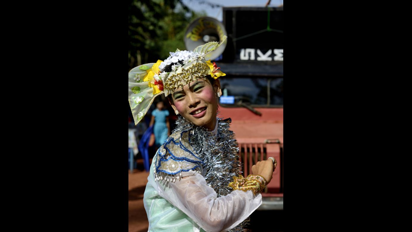 A young Burmese man dressed as a woman entertains residents of a neighborhood in Mawlamyine.