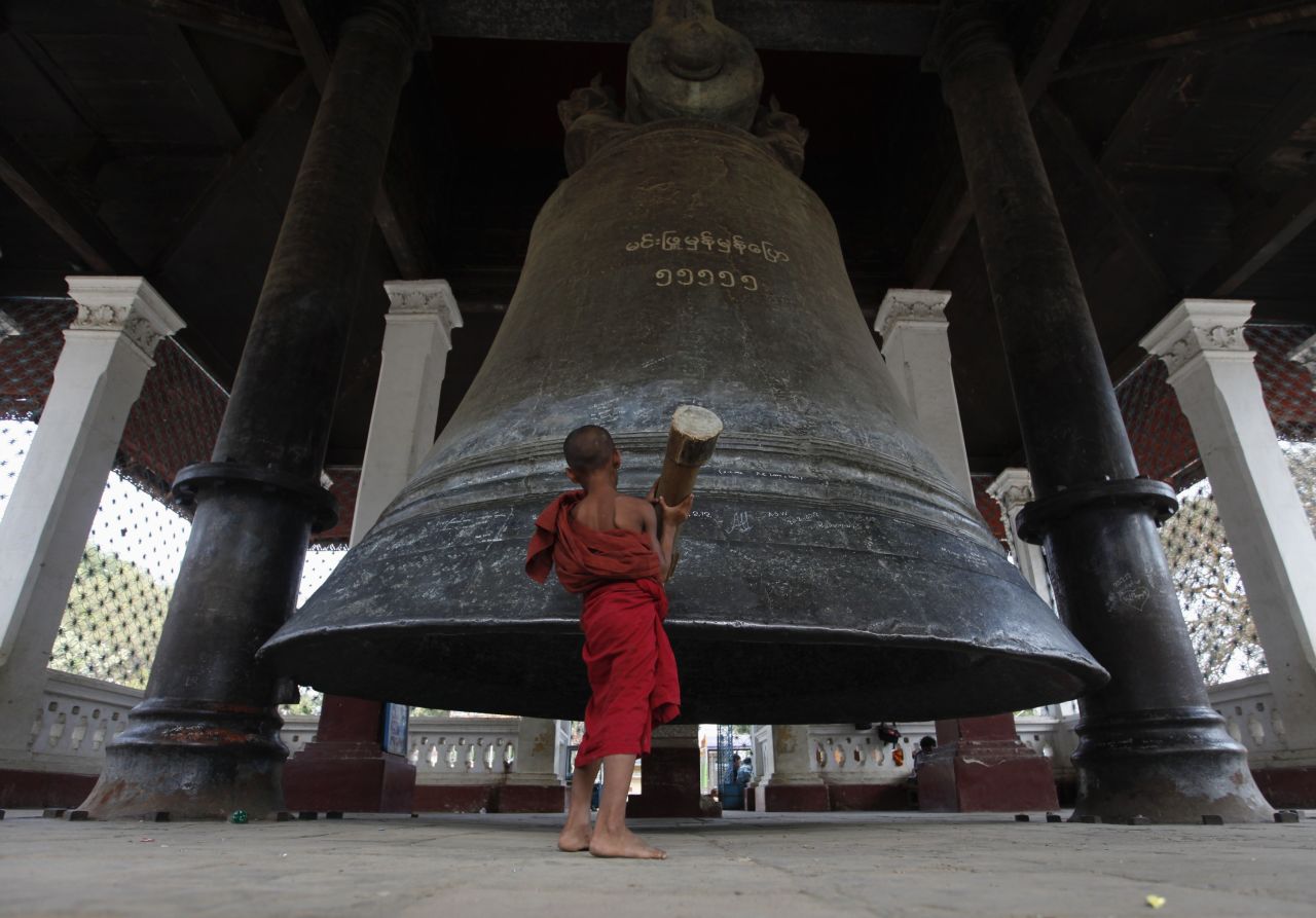 A novice monk rings the Mingun Bell, the world's third-largest bell, in Mingun village, about 21 kilometers (13 miles) southwest of Mandalay.
