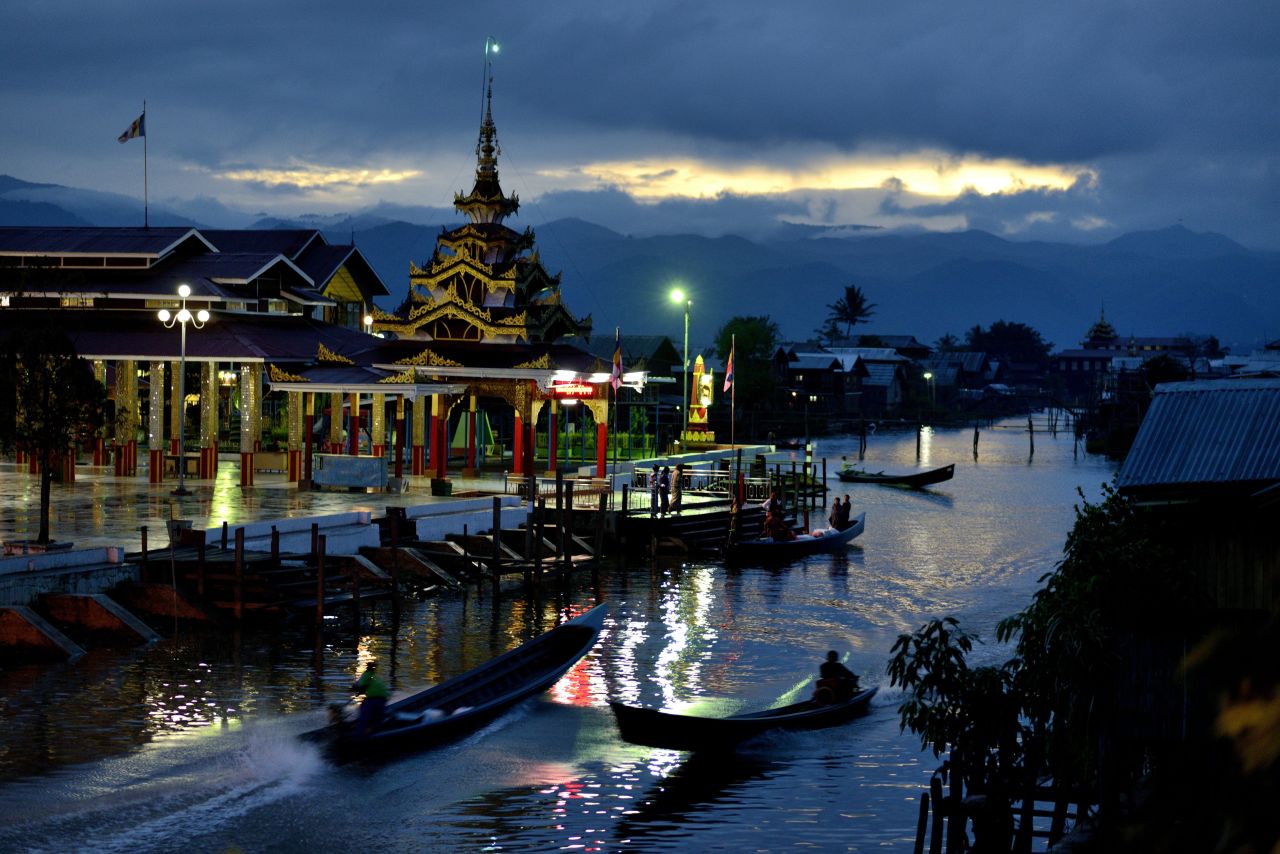 The temple of Phaung Daw U, the largest on Inle Lake, is lit as dusk falls in the village of Ywama.