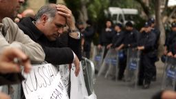 An employee of Cyprus Laiki (Popular) Bank reacts as he takes part in a protest outside the parliament in Nicosia on March 22, 2013. Cyprus is locked in 'hard negotiations' with a troika of lenders to save the eurozone member's banking system and economy in general from ruin, government spokesman Christos Stylianides said. AFP PHOTO/PATRICK BAZ (Photo credit should read PATRICK BAZ/AFP/Getty Images) 