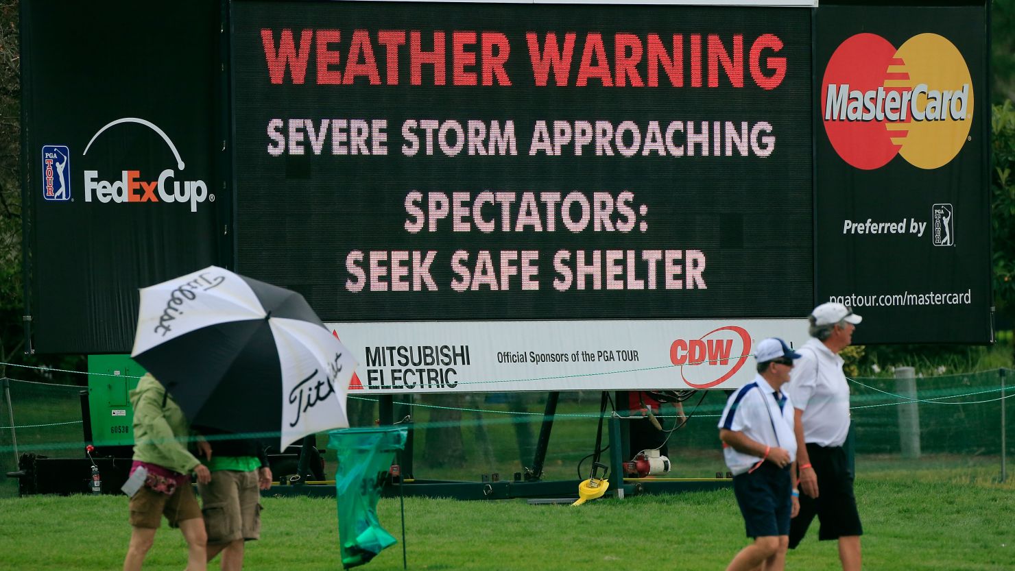 Fans seek shelter during the final round of the Arnold Palmer Invitational at the Bay Hill Club and Lodge in Orlando, Florida.