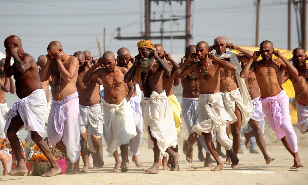 Bihari Hindu priests run while holding their ears during a ritual at the Sangam on March 6.