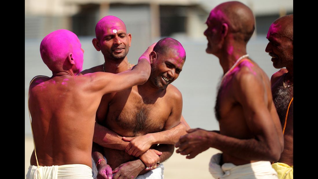 Bihari Hindu priests smear colored powder on each other after a ritual at the Sangam on March 6.