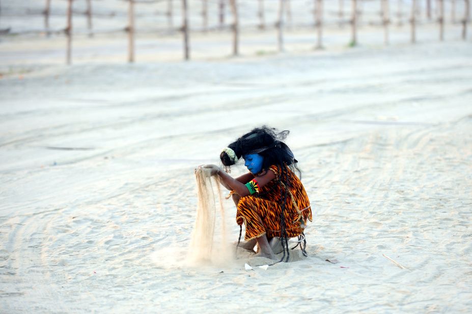 An Indian child dressed as the Hindu god Shiva plays with sand on the banks of the Sangam in Allahabad on March 5. 