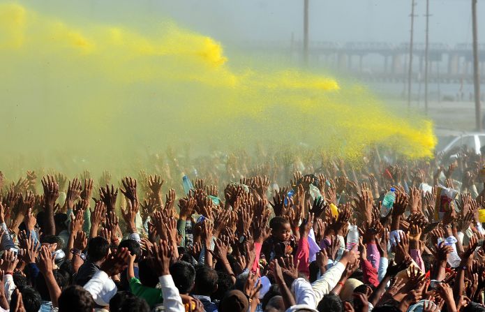 Colored powder billows over the crowd during the Kumbh Mela festival in Allahabad, India, on March 9, 2013, during which pilgrims symbolically wash off their sins in a two-month-long festival.