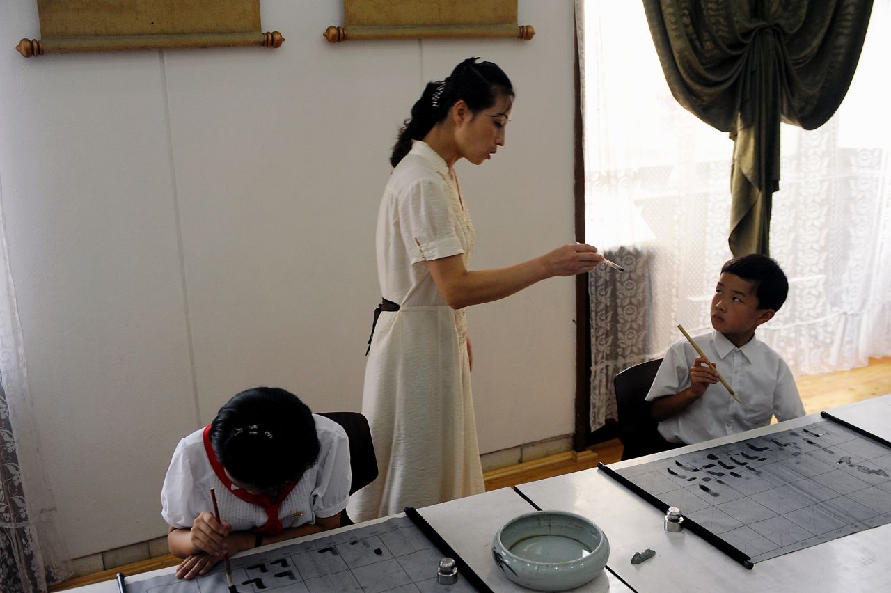 At Mangyongdae School Children's Palace in Pyongyang, privileged children from 6 to 17 years can learn foreign languages, how to play an instrument or participate in dance and gymnastic courses. Others take art classes or, like the boy in the picture, learn calligraphy.