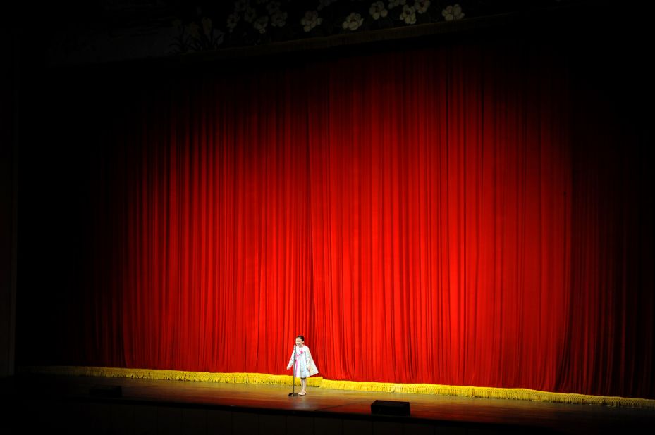 A North Korean girl stands onstage at Mangyongdae School Children's Palace during a showcase of student talents.