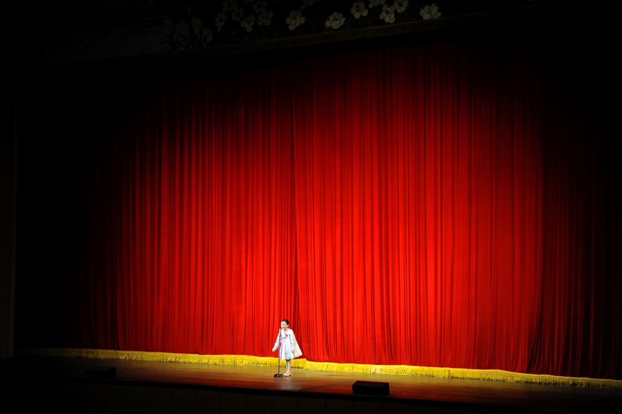 A North Korean girl stands onstage at Mangyongdae School Children's Palace during a showcase of student talents.