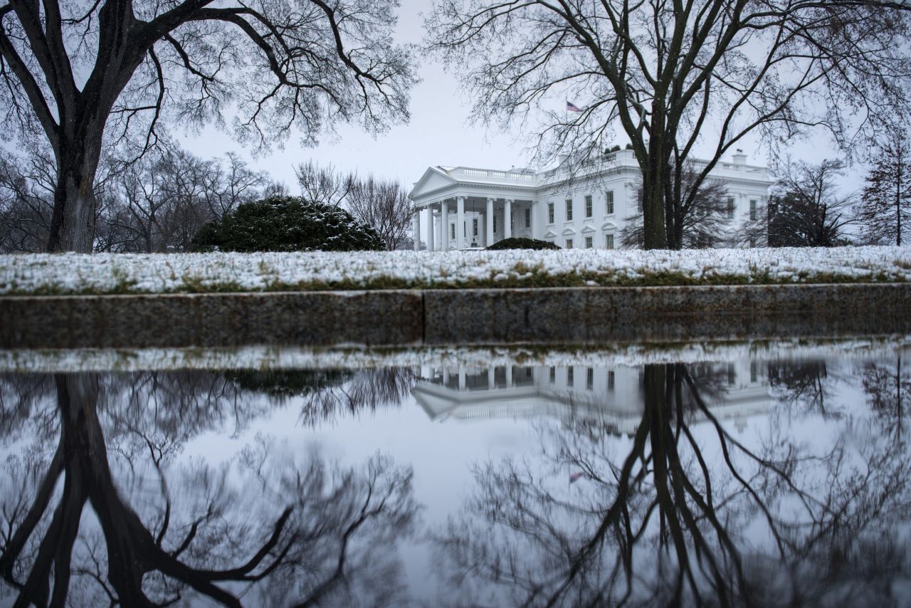 Snow covers the shrubbery around the White House on Monday, March 25.