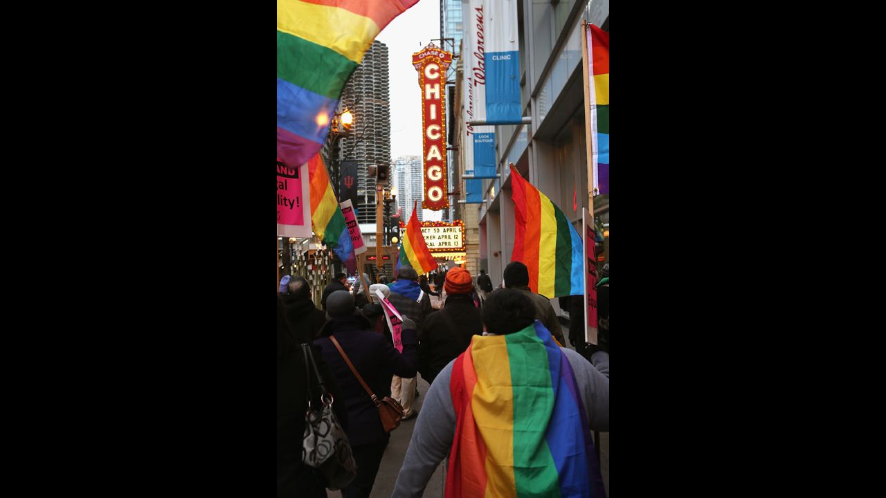 Demonstrators carry flags through the streets of Chicago on March 25.