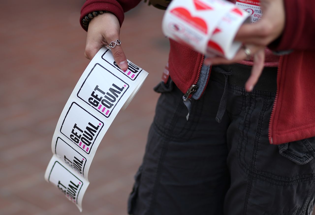A supporter of same-sex marriage passes out stickers in San Francisco.