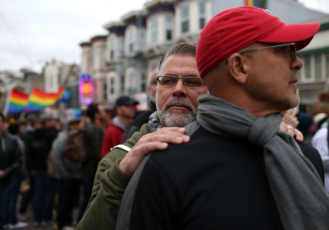 Ken Mauldin, left, hugs Larry Davanzo during the demonstration in San Francisco.