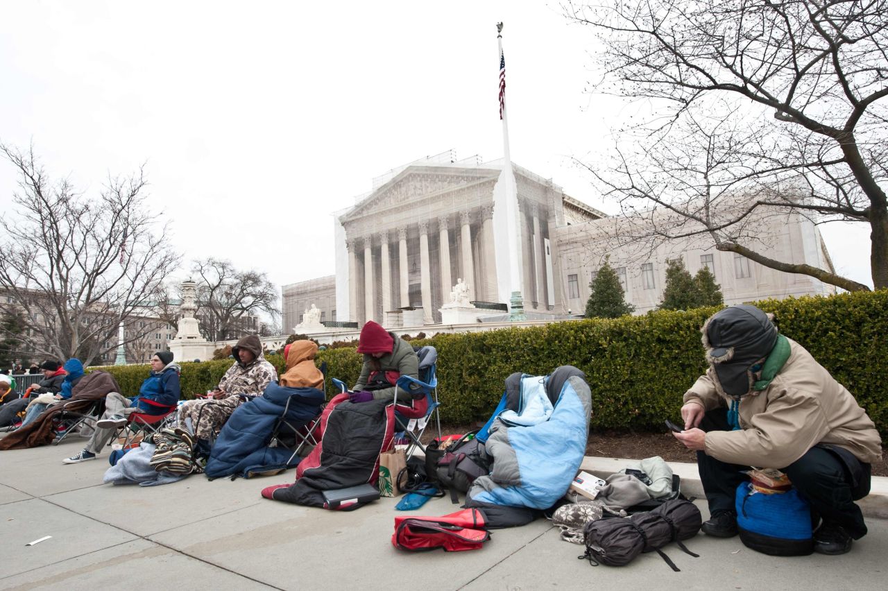 People rest in front of the Supreme Court in Washington on March 24 in the line for the hearing.