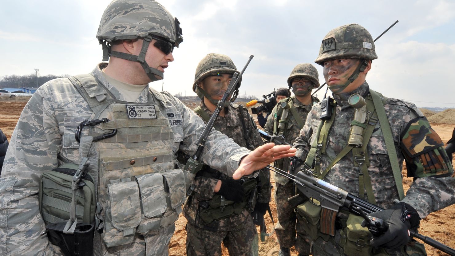 A US Air Force soldier (L) talks to South Korean soldiers during annual joint exercises south of Seoul, on March 14.