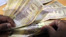 A bank cashier counts Indian Rupee notes at a bank in Mumbai on November 22, 2011.