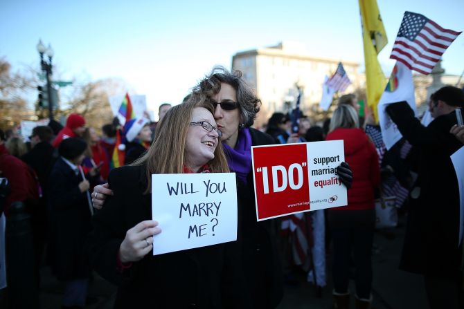 Andrea Grill, right, and Lee Ann Hopkins from Alexandria, Virginia, embrace after becoming engaged during a rally Tuesday. 