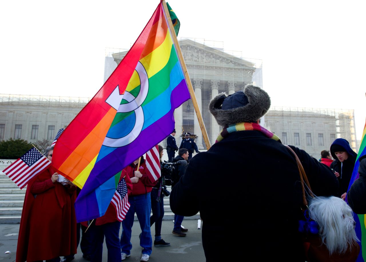 A protester carries a rainbow flag Tuesday.