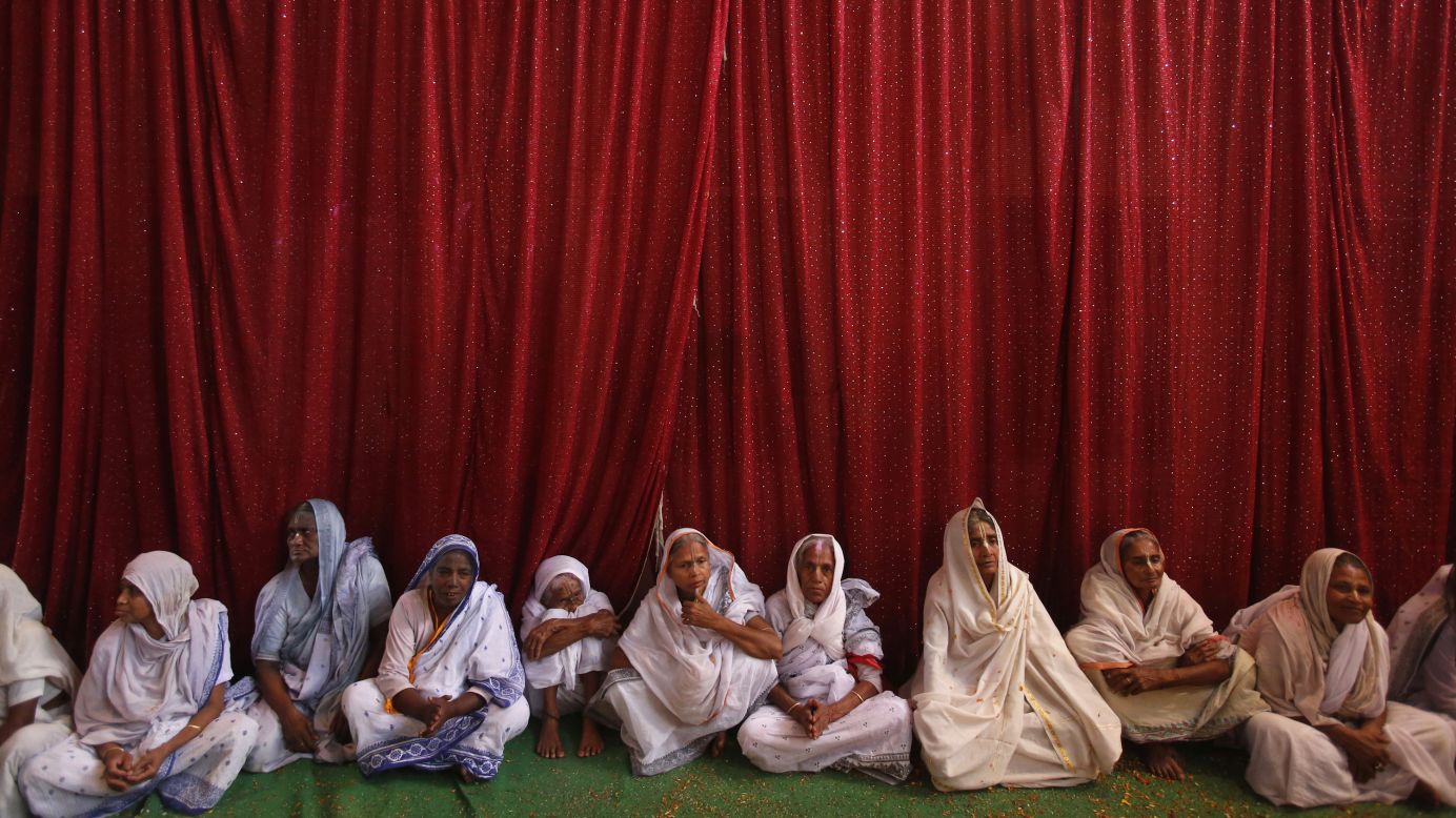 Widows sit on the ground during celebrations at the Meera Sahavagini ashram in Vrindavan on Sunday, March 24. In Hindu culture, widows are expected to renounce earthly pleasure, so they do not celebrate Holi, but for the first time, women at the shelter for widows who have been abandoned by their families celebrated the festival by throwing flowers and colored powder.