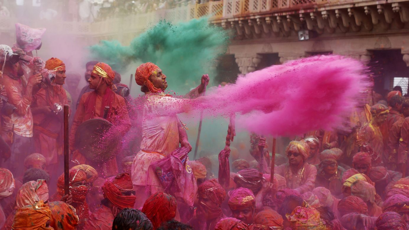 A man flings pink powder over celebrants in Nandgaon on March 22.