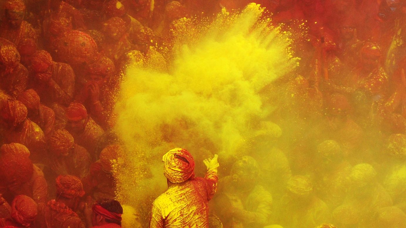 Devotees brace for another barrage of colored powder at the Radha Rani temple in Barsana, India, on Thursday, March 21.