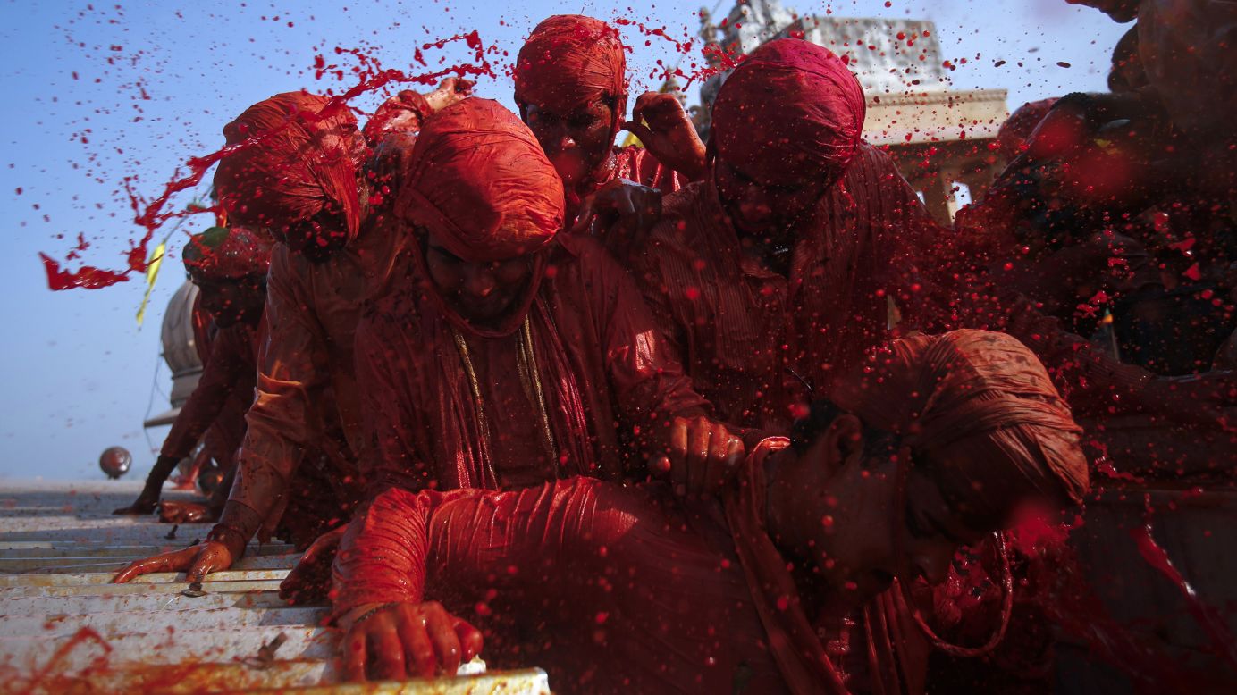 Devotees throw colored water at each other at a temple in Barsana on March 21.