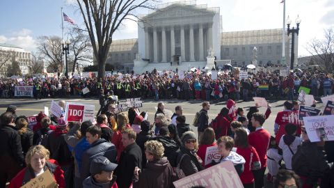 Crowds gather outside the Supreme Court on Tuesday as justices hear the first case on same-sex marriage.
