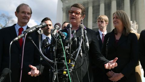Plaintiffs Kris Perry, center, and Sandy Stier, right, talk to the media with attorney David Boies, left, after arguments Tuesday at the Supreme Court.