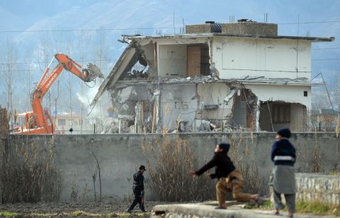 A demolition crew works to dismantle the compound on February 26, 2012.