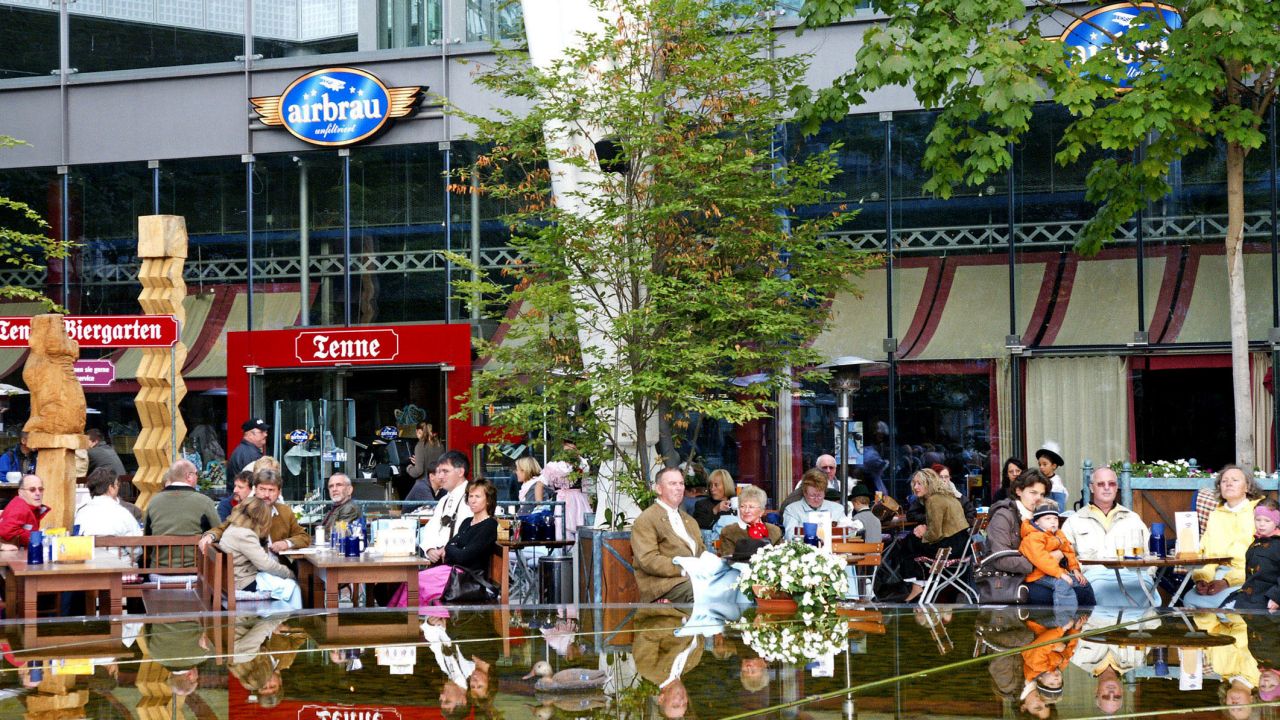 Travelers relax in Munich Airport's beer garden.