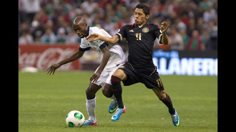 Javier Aquino of Mexico fights for the ball with DaMarcus Beasley of the U.S.