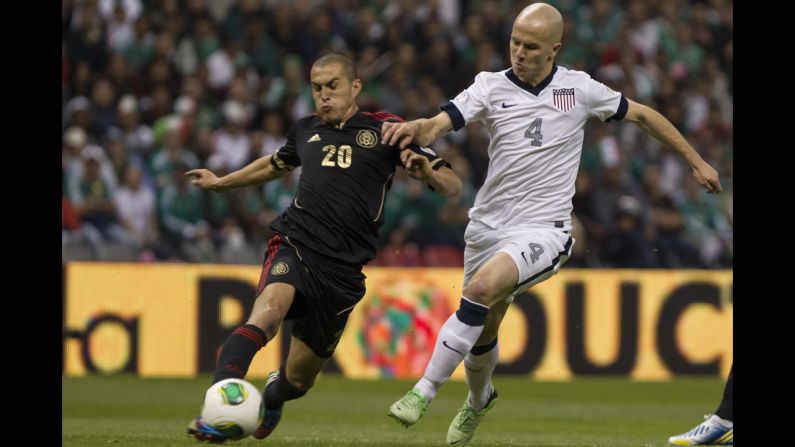 Jorge Torres of Mexico and Michael Bradley of the U.S. struggle for control of the ball.