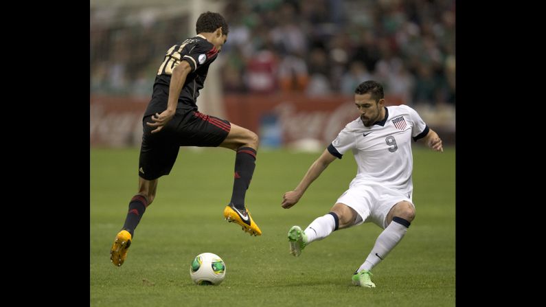 Mexican defender Diego Reyes vies for the ball with Hercules Gomez.