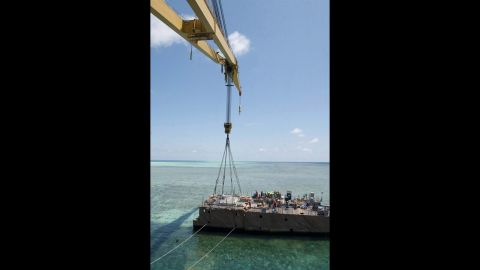 The crane vessel removes a hull section on Wednesday, March 27.  The U.S. Navy expects the Guardian to be completely removed from Tubbataha Reef by mid-April, an official says.