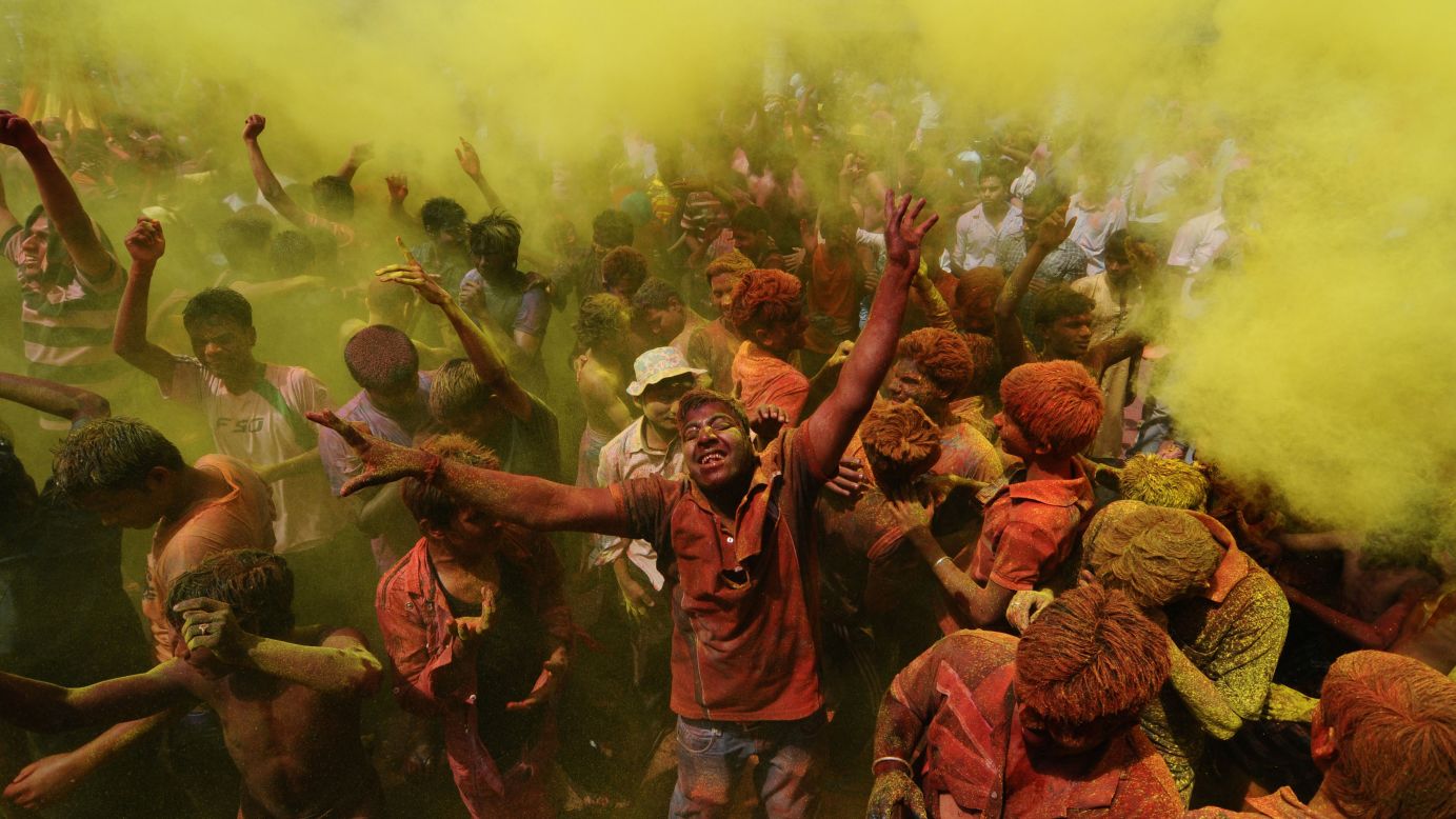 Revelers cover each other with colored powder during Holi celebrations in Guwahati, India, on March 27.
