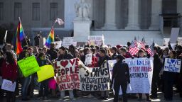 Supporters of same-sex marriage wave flags and signs as they rally in front of the U.S. Supreme Court on Wednesday, March 27, in Washington. The justices heard two cases this week related to state and federal laws restricting same-sex marriage.