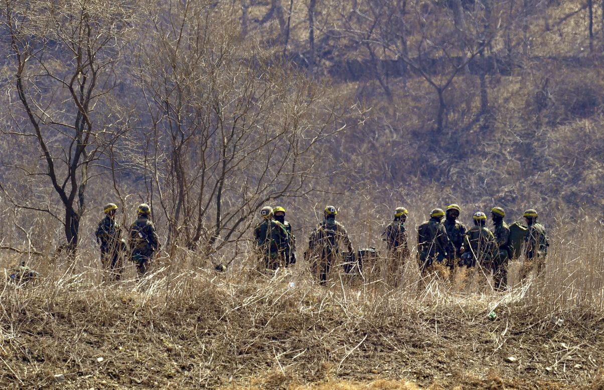 South Korean soldiers gather at the foot of a mountain near a military drill field in the border city of Paju on Wednesday, March 27. 