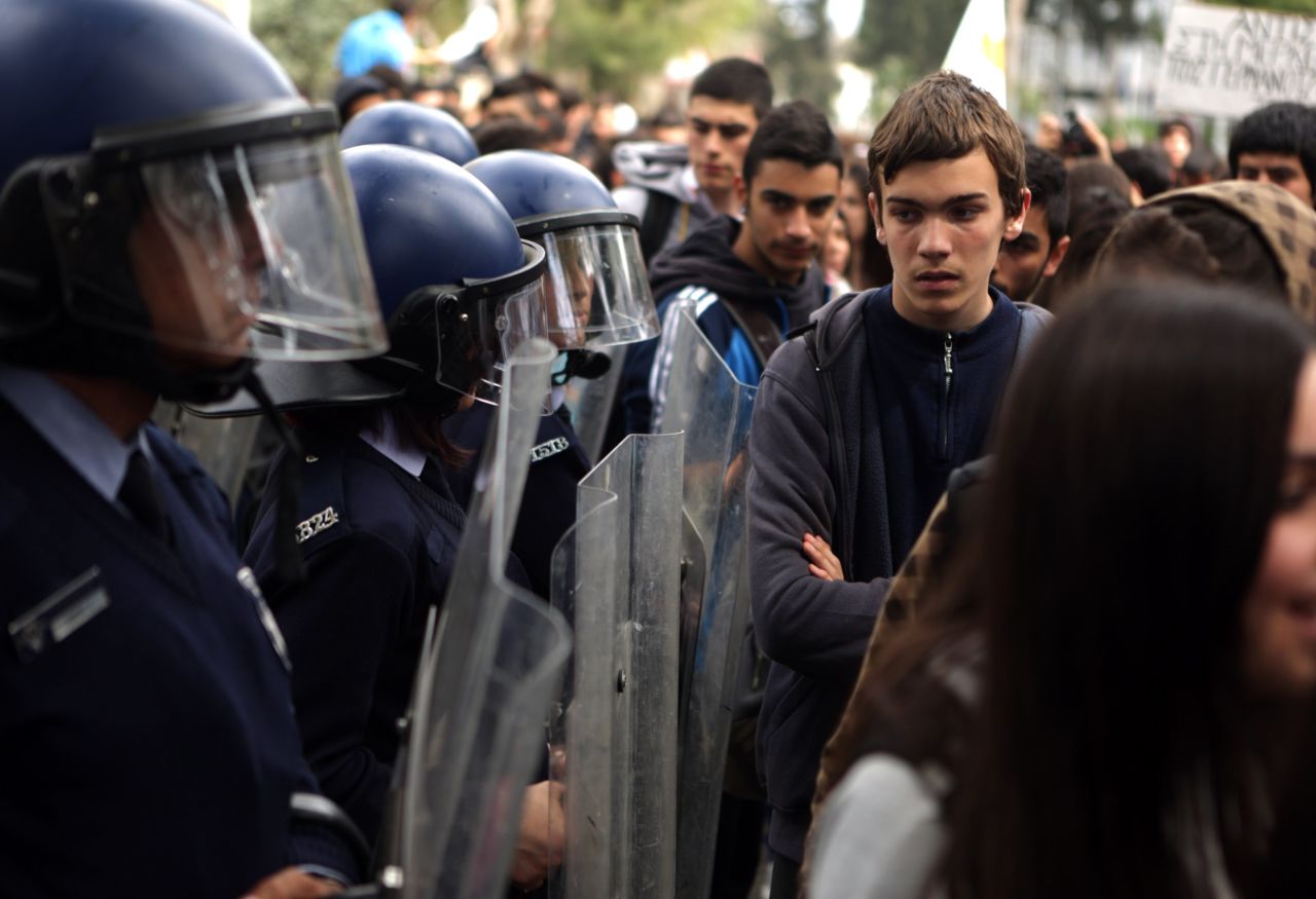 Riot police stand guard outside the European Union House as college students gather for a protest in Nicosia, Cyprus, against a bailout  on March 26.